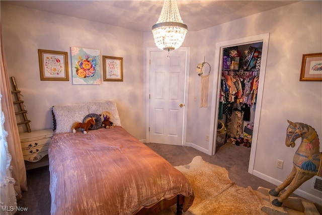 carpeted bedroom featuring an inviting chandelier, a walk in closet, and a closet