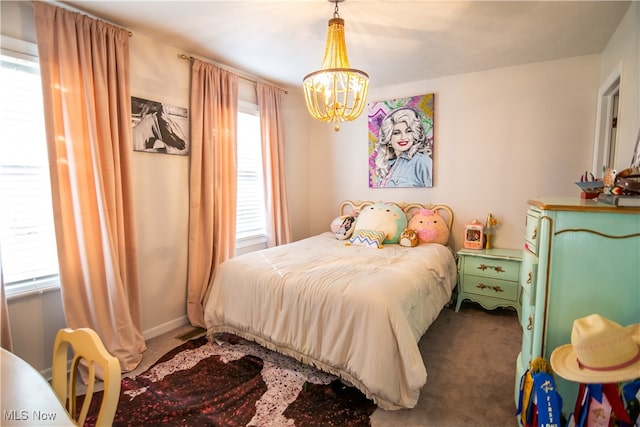 carpeted bedroom with a notable chandelier