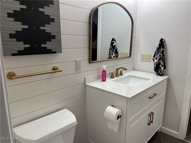 bathroom featuring hardwood / wood-style floors, vanity, and toilet