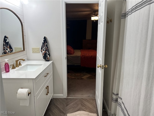 bathroom with vanity and parquet floors