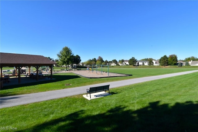 view of community with a playground, a gazebo, and a lawn