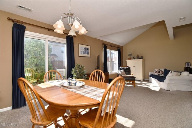 carpeted dining space featuring lofted ceiling, a wealth of natural light, and an inviting chandelier