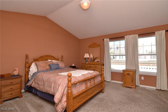 carpeted bedroom with vaulted ceiling