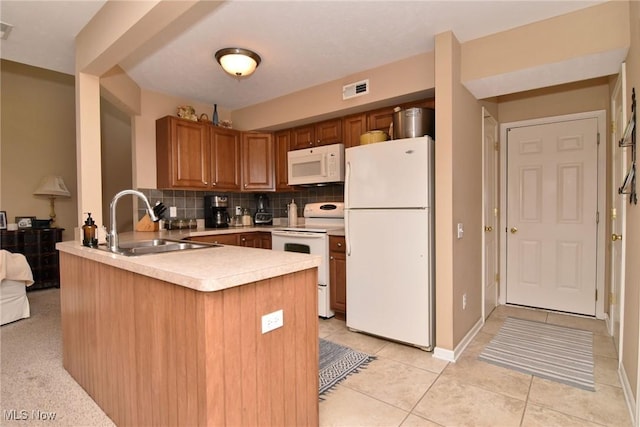 kitchen featuring sink, light tile patterned floors, kitchen peninsula, white appliances, and backsplash