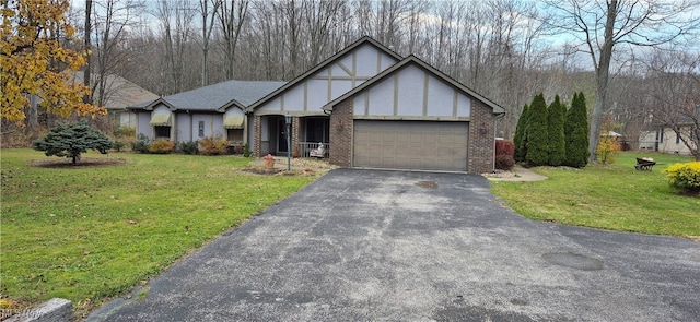 tudor-style house with a front lawn and a garage