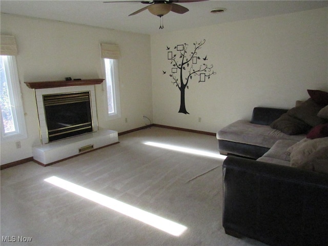 unfurnished living room with carpet flooring and ceiling fan