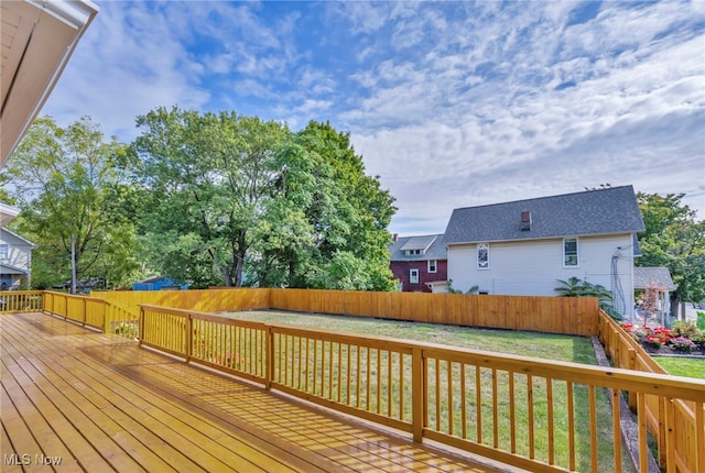 wooden deck featuring a yard