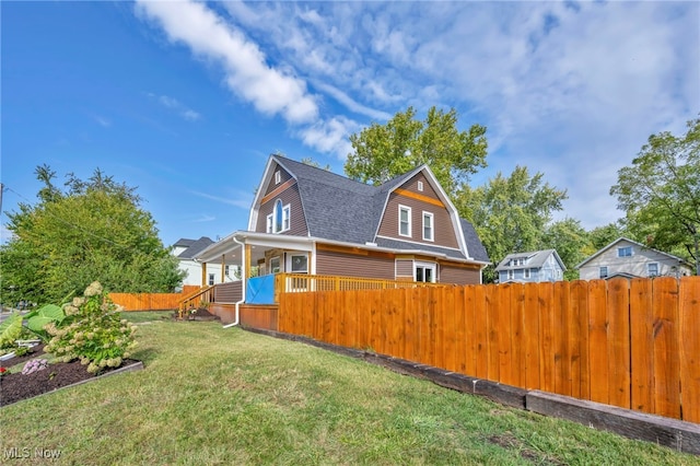 rear view of house featuring a yard