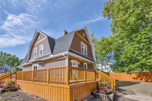 rear view of property with a wooden deck