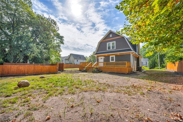 back of property featuring a wooden deck