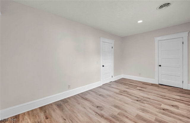 spare room featuring light hardwood / wood-style flooring