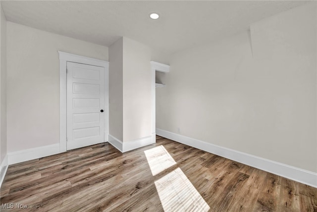 unfurnished room with hardwood / wood-style flooring