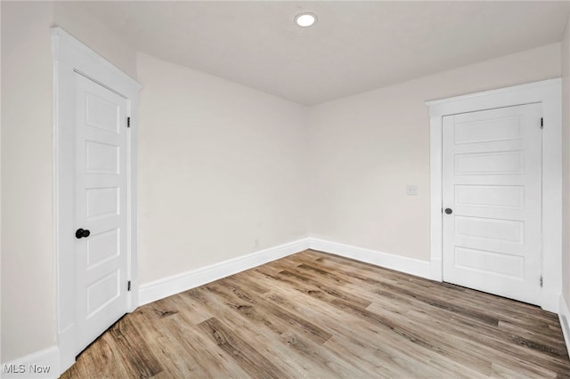 unfurnished room with hardwood / wood-style flooring