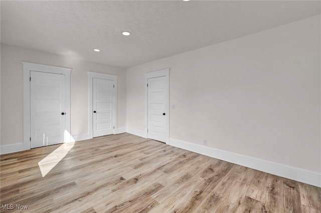 interior space featuring light hardwood / wood-style floors and a textured ceiling