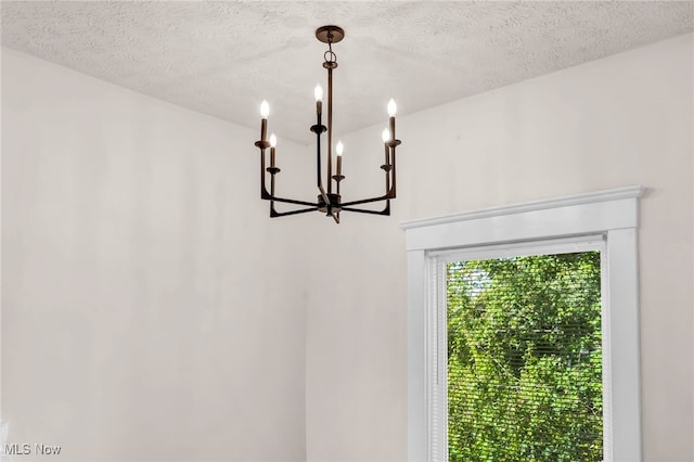 room details with a chandelier and a textured ceiling