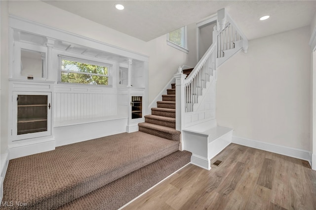 staircase featuring hardwood / wood-style flooring