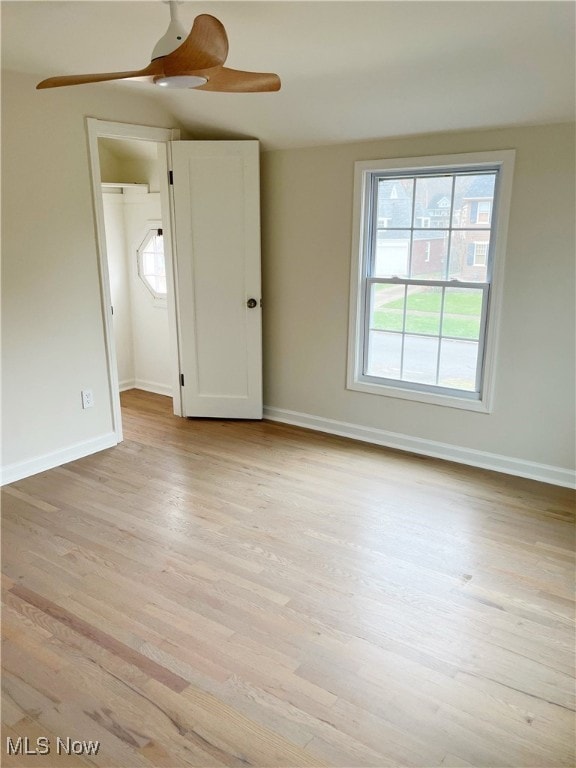 interior space featuring multiple windows, a closet, and light wood-type flooring