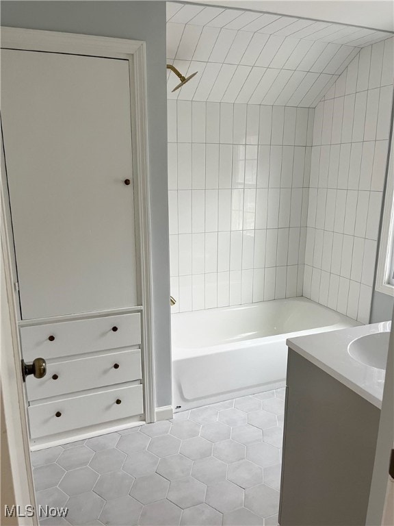 bathroom featuring tile patterned floors, vanity, and tiled shower / bath combo