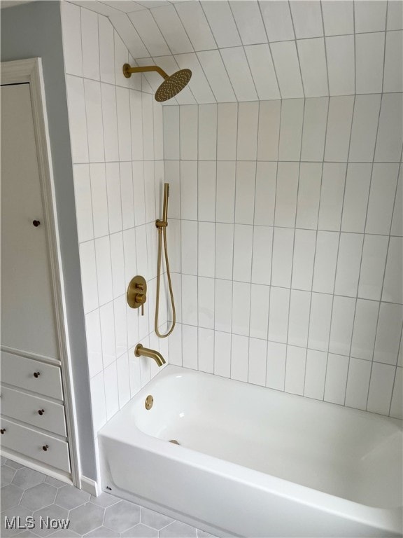 bathroom with tile patterned floors and tiled shower / bath