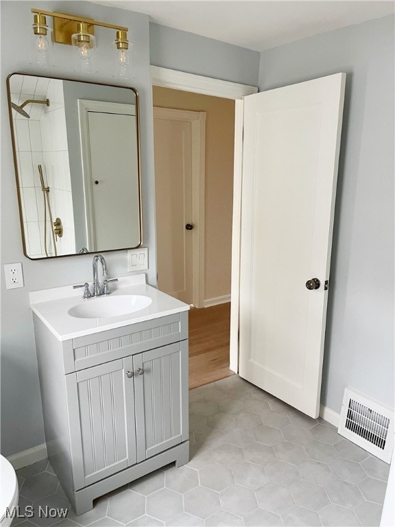 bathroom with hardwood / wood-style flooring and vanity