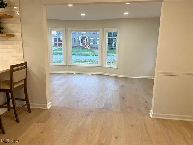 unfurnished dining area with light hardwood / wood-style flooring