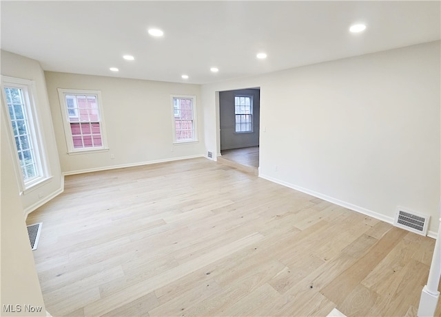 unfurnished room with light wood-type flooring