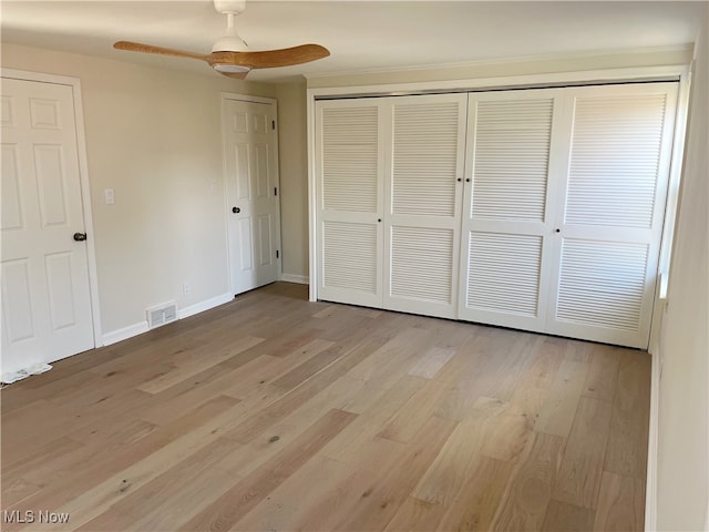 unfurnished bedroom with ceiling fan and light wood-type flooring