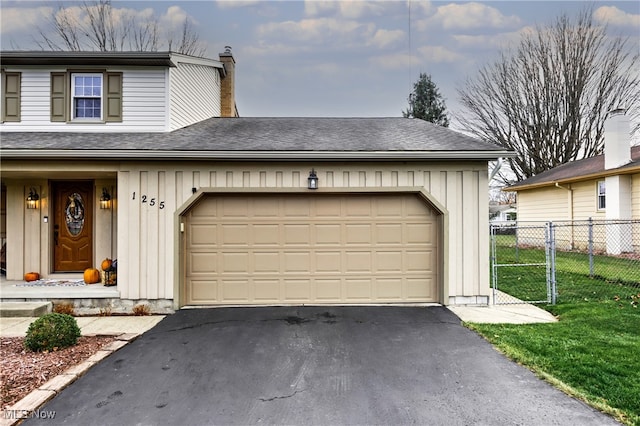 view of front of home with a garage and a front lawn