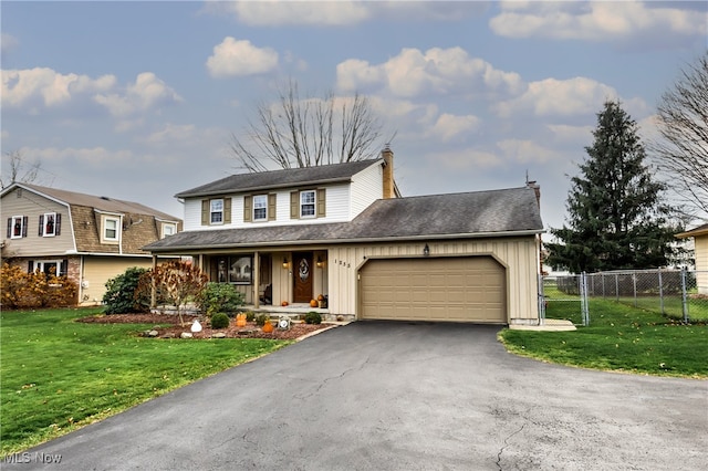 view of front property with a porch, a front yard, and a garage