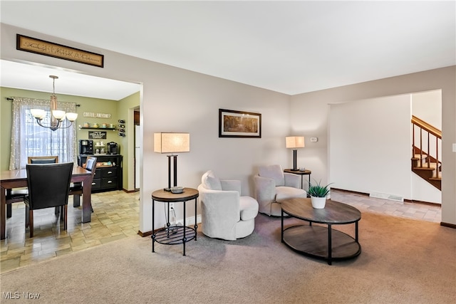 living room featuring light colored carpet and an inviting chandelier