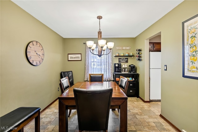 dining area featuring an inviting chandelier