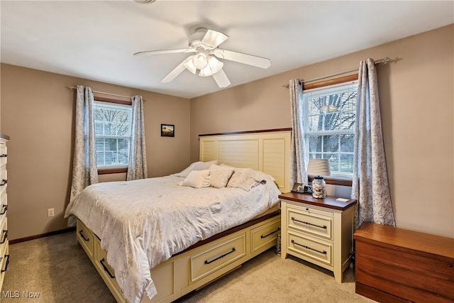 bedroom with ceiling fan and light carpet