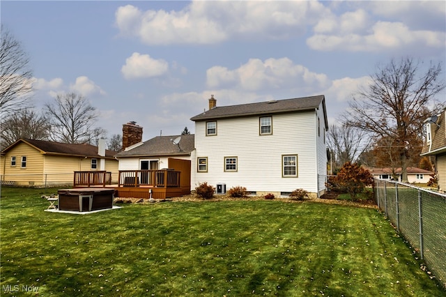 back of property with a lawn and a wooden deck