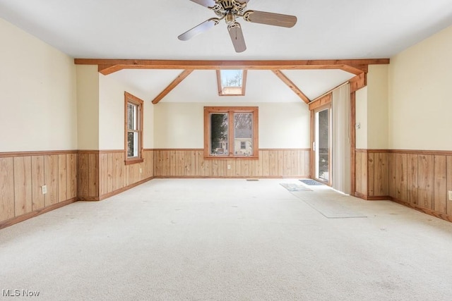 18061 Derr Ave, Beloit, OH 44609 - spare room featuring wainscoting, wood walls, a ceiling fan, healthy amount of natural light, and carpet flooring