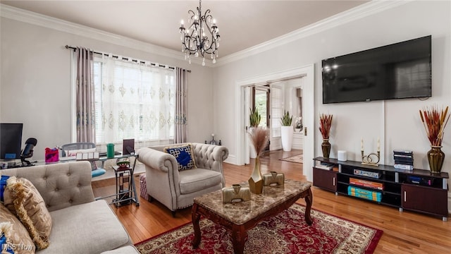 living room with a chandelier, wood-type flooring, and ornamental molding