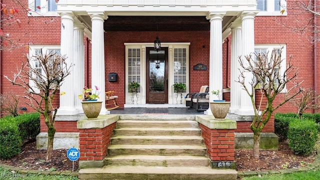 view of exterior entry featuring a porch