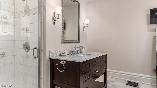 bathroom featuring vanity and a shower with shower door