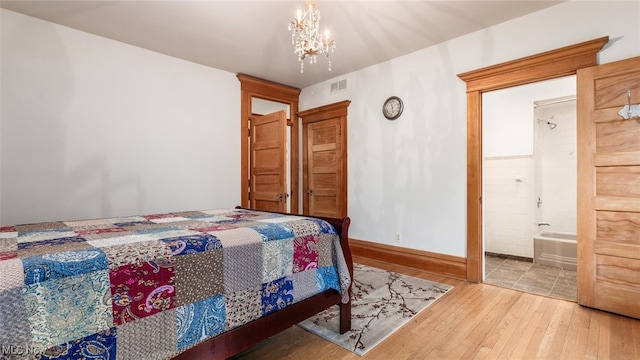 bedroom featuring a chandelier and hardwood / wood-style floors