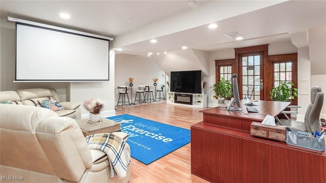 home theater with light wood-type flooring