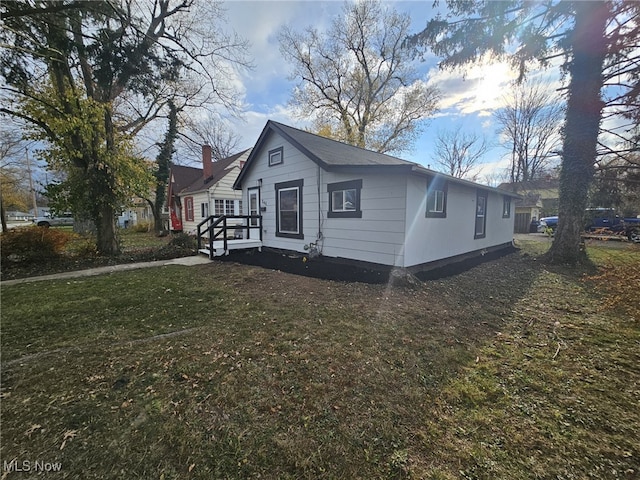 view of front of home featuring a front yard and a deck