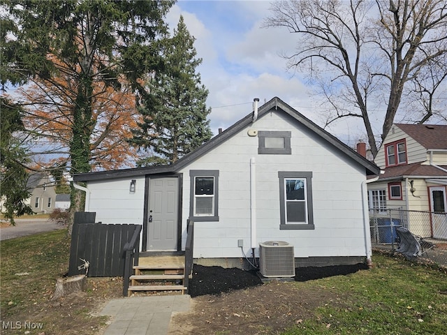 rear view of house with central AC unit