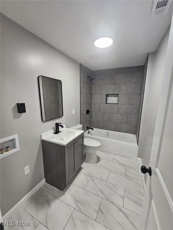 full bathroom with vanity, tiled shower / bath combo, and toilet