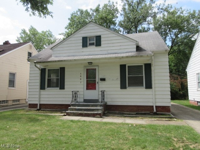 bungalow-style home with a front lawn