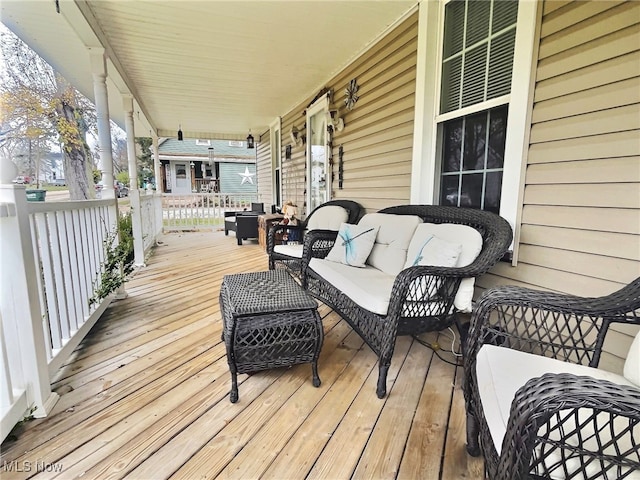 deck featuring an outdoor living space and a porch