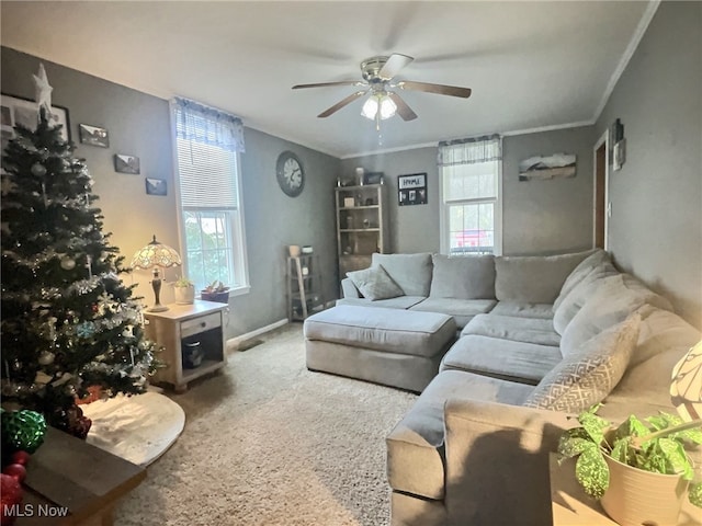 carpeted living room featuring ceiling fan and crown molding