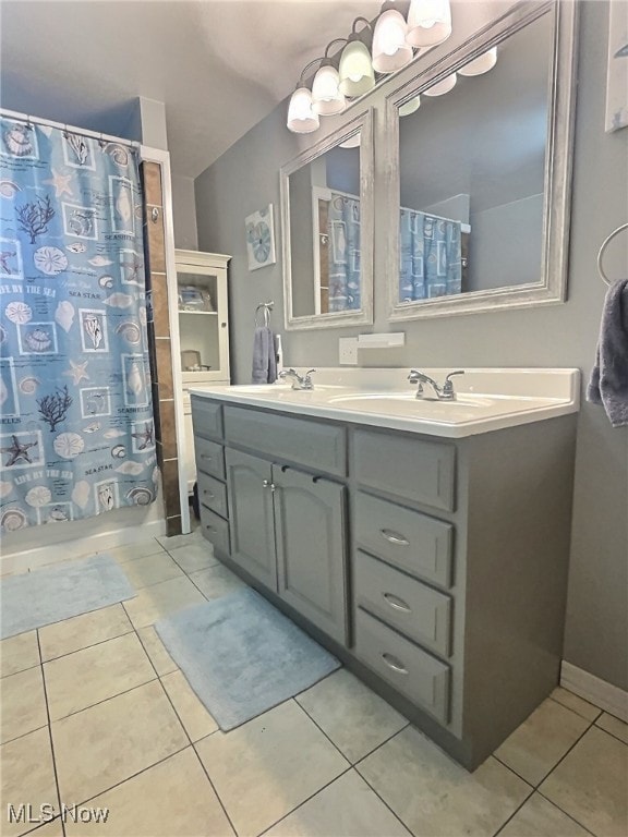 bathroom with tile patterned flooring, vanity, and shower / tub combo with curtain