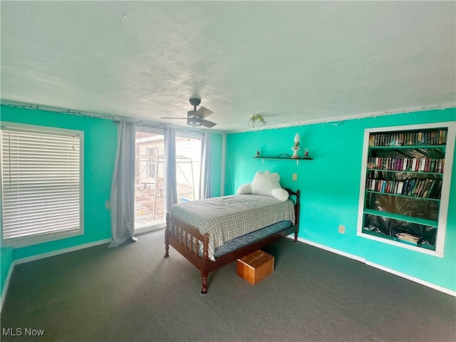 bedroom featuring carpet flooring, ceiling fan, and a textured ceiling