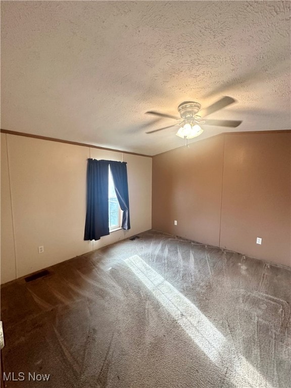 spare room with carpet flooring, a textured ceiling, and ceiling fan