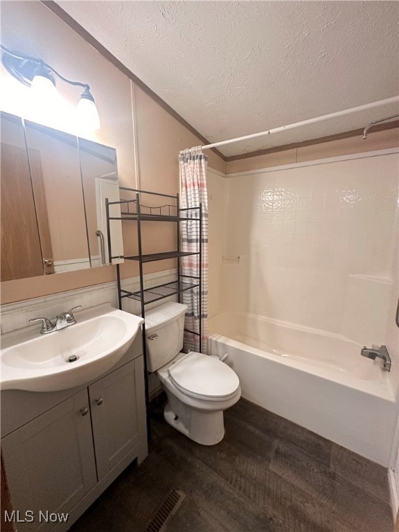 full bathroom featuring shower / bathtub combination with curtain, wood-type flooring, a textured ceiling, toilet, and vanity