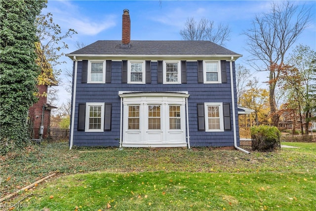 back of house featuring a yard